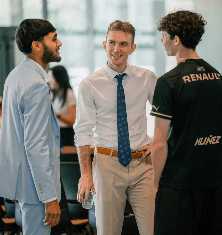 Three people sharing a conversation at an entrepreneurship gathering.